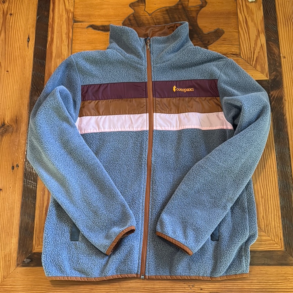 Cotopaxi Blue Fleece Jacket with Brown and pink accents